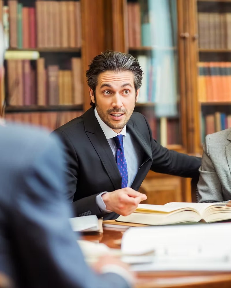 Counsel advising clients in a law library
